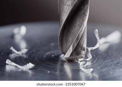 metal drill bit make holes in steel billet on industrial drilling machine. Metal work industry. multi cutting tool and end mill. - Powered by Shutterstock