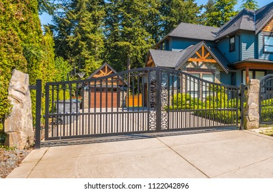 Metal driveway entrance gates to the residential house, community.