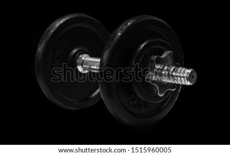 The metal dumbbell isolated on black background