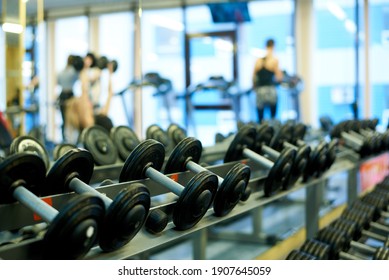 Metal dumbbells for strength training in the gym.