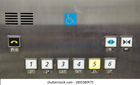 Metal elevator control pane with round button with number of layers button