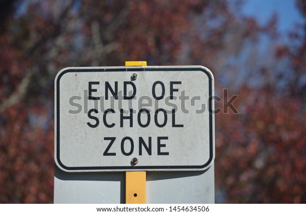 Metal end of school zone\
sign
