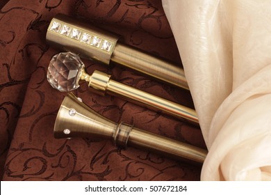 Metal ending for cornices and the folded fabric. Curtain rod and finials on the folded fabric - Shutterstock ID 507672184