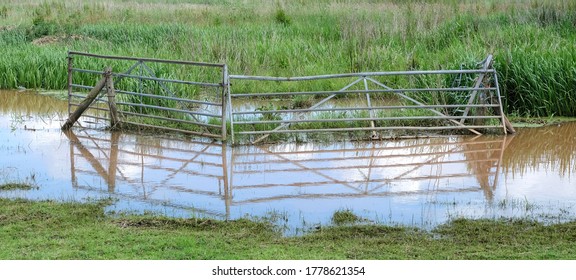 Metal Farm Gate On Flooded Land