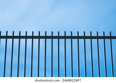 metal fence against the blue sky close-up. - Powered by Shutterstock