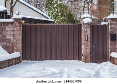 Metal Fence By The Private House At Winter Time.