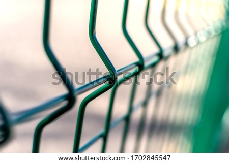 Metal fence close-up. Territory fencing, green fence.