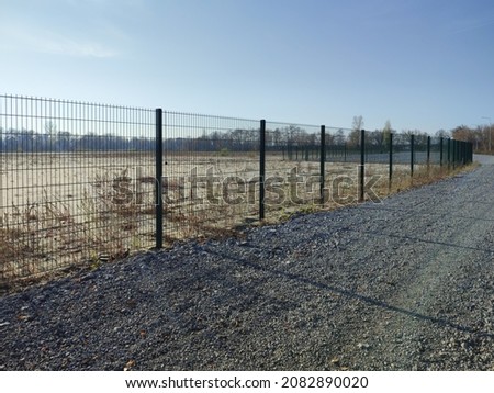 Metal fence green fence, barrage street, autumn.