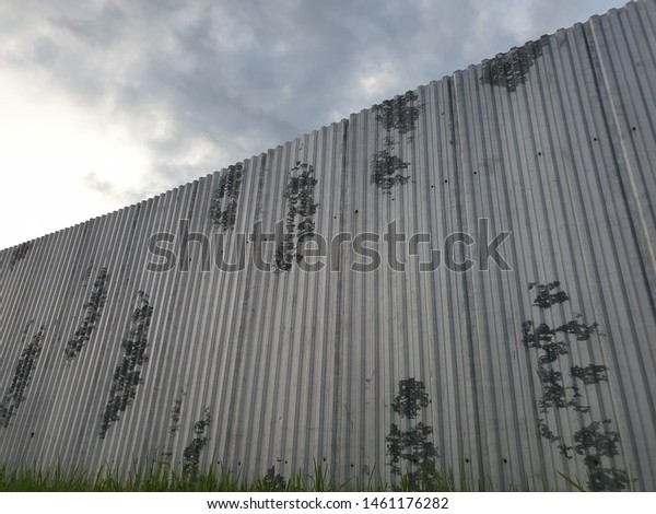 Metal fence. High corrugated metal fence. Fence\
in the close-up