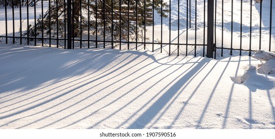 Metal Fence In The Snow In Winter In A Park Landscape