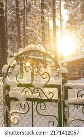 Metal Fence In Snow In Winter With Sunset