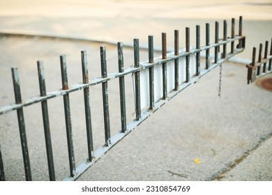 Metal fence symbolizes boundaries, security, protection, privacy, and delineates spaces with its strong and sturdy presence - Shutterstock ID 2310854769
