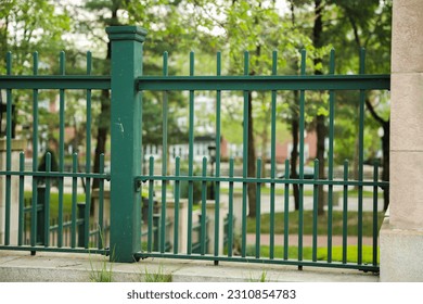 Metal fence symbolizes boundaries, security, protection, privacy, and delineates spaces with its strong and sturdy presence - Shutterstock ID 2310854783