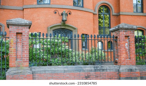 Metal fence symbolizes boundaries, security, protection, privacy, and delineates spaces with its strong and sturdy presence - Shutterstock ID 2310854785