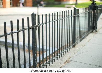 Metal fence symbolizes boundaries, security, protection, privacy, and delineates spaces with its strong and sturdy presence - Shutterstock ID 2310854787