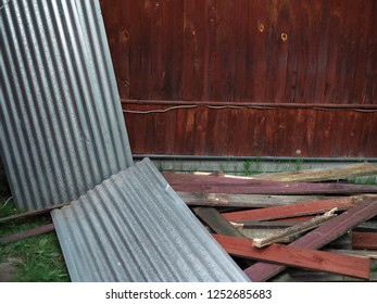 Metal Fencing Panels And Wooden Planks Scattered In Mess In A Backyard