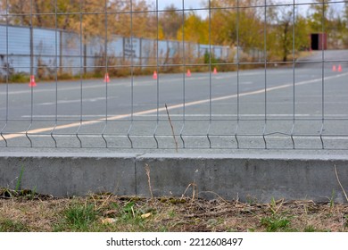 Metal Fencing Of A Parking Lot On An Autumn Day