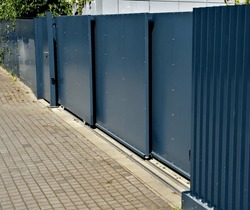 Metal Fillings Of The Fence With An Underlay Of Concrete Blocks. A Metal Aluminum Fence Will Provide Privacy Around The Garden. Horizontal Slats Cover Well.  Made Concrete Block Brick Protection