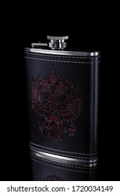 Metal flask in a leather case with a pattern depicting a doubleheaded eagle on a black background