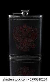 Metal flask in a leather case with a pattern depicting a doubleheaded eagle on a black background