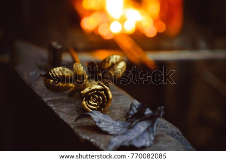 A metal forged rose lies on the pier in the smithy Stock photo © 