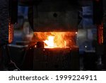 metal forging, forging shop. hydraulic hammer shapes the red-hot billet. the production of high-tech parts