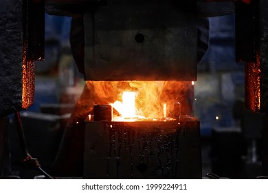 metal forging, forging shop. hydraulic hammer shapes the red-hot billet. the production of high-tech parts - Powered by Shutterstock