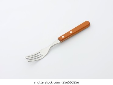 Metal Fork With A Wooden Handle On White Background