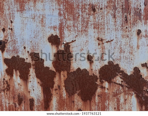 Metal fragment covered with light paint and\
large spots of corrosion