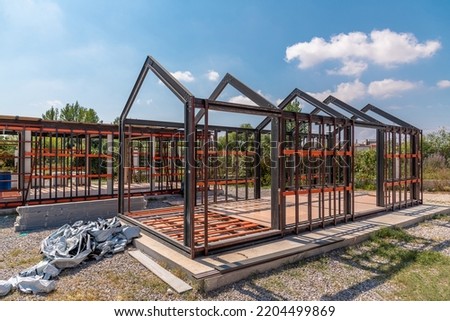 Metal frame of newly built building. Construction of a new tiny house