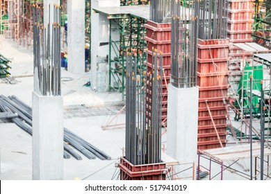 Metal frame piles. Preparation works for concrete pouring. High-rise building under construction. Under-construction of concrete building for car parking.