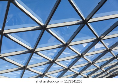 Metal framework with structural glazing. Abstract architectural or industrial background in hi-tech style. Photo of modern architecture fragment. 