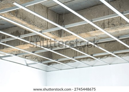 The metal framework for the suspended ceiling is currently being installed.
The C-line main runners and cross tees are neatly aligned to create a sturdy base for the ceiling.