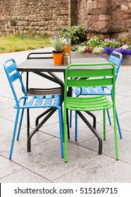 Metal Garden Furniture Of Table And Chairs On A Patio Or Street Restaurant. 