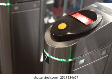 A metal gate with a red light on electronic turnstiles. Turnstile is a close-up. Control and security - Powered by Shutterstock