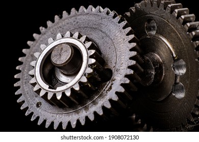 Metal Gears From An Internal Combustion Engine. Torque Transmitting Components. Dark Background.