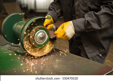 Metal grinding. Cropped shot of a man working on a grinding wheel with sparks all around at his workshop   - Powered by Shutterstock