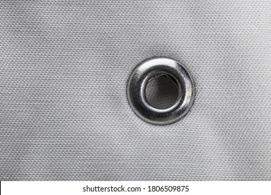 Metal Grommet On Grey Raincoat Fabric