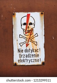 Metal Grungy Old Warning Sign, Door Of Electric Meter, Industrial Electrical Equipment In Poland. Do Not Touch! Electrical Equipment!. Electricity Danger Sign With Skull