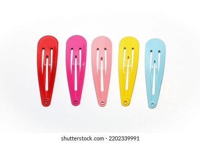 Metal hairclips in various colors such as red, pink, peach, yellow, and blue isolated on white backgroud. Hairpins accessories for girls.