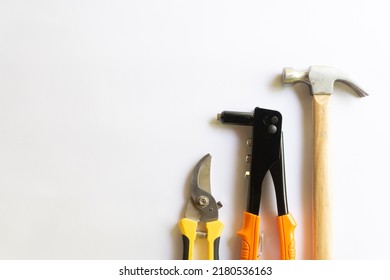 Metal Hammer With Wood Handle, Rivet Tool And Pruning Scissors Or Garden Trimmer With Various Layouts Isolated On A White Background.