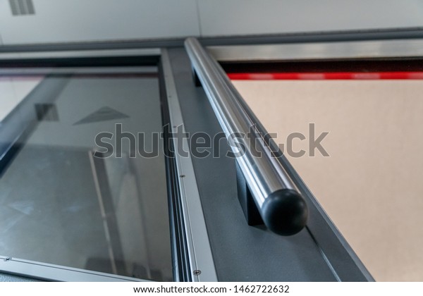 Metal handle in the elevator in order\
to hold on to it. Open the elevator door with mso\
glass