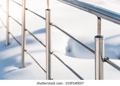 Metal handrail on winter stairs. Dangerous stairs under snow, safe handrail. - Powered by Shutterstock