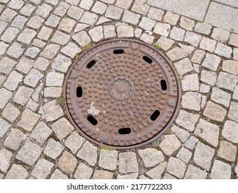 Metal Hatch On Paving Stones.