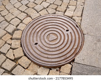 Metal Hatch On Paving Stones.