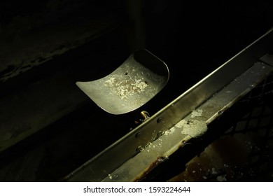 Metal Headrest Attached To An Embalming Table In An Abandoned Psychiatric Hospital. Natural Light.                                