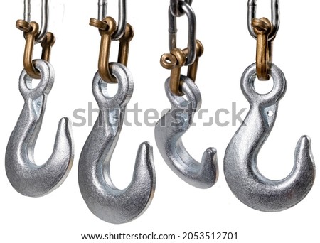 Metal hook on a chain for lifting heavy objects in the workshop. 