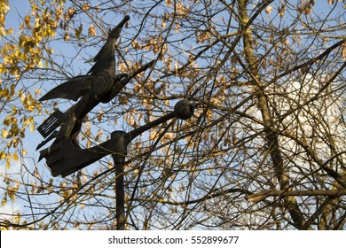 A Metal Horse Weather Vane On A Roof.