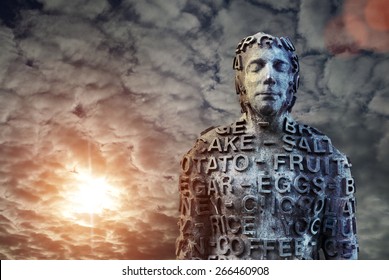 Metal human statue covered with letters