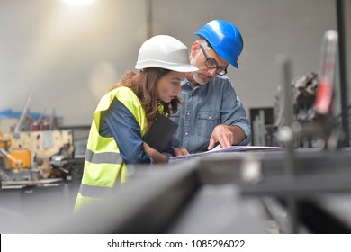 Metal industry manager and engineer meeting in factory - Shutterstock ID 1085296022